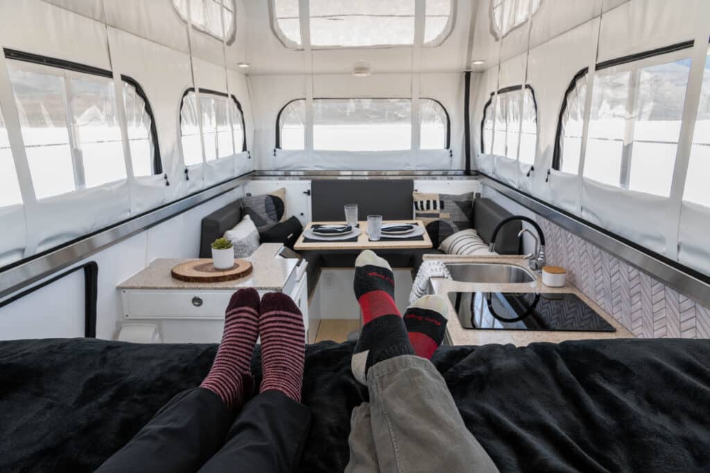Terranova interior with two adults lounging on the bed